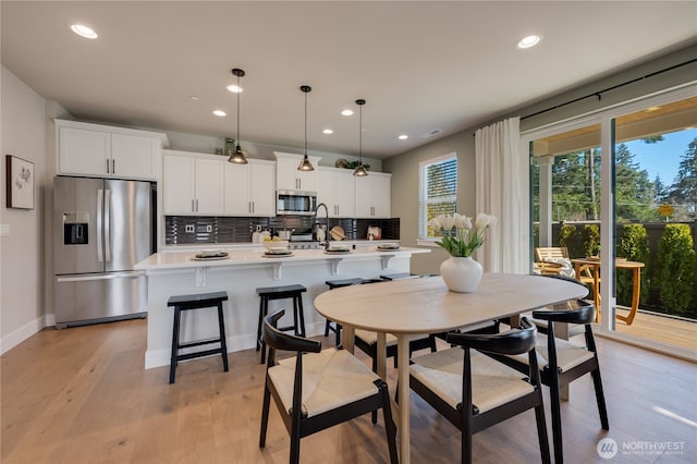 dining area with recessed lighting, baseboards, and light wood-style floors