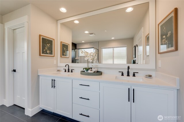 bathroom featuring a sink, recessed lighting, double vanity, and tile patterned flooring