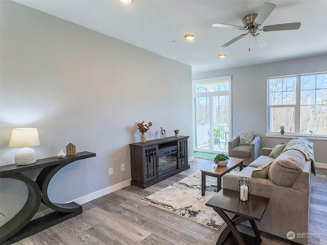 living room featuring hardwood / wood-style flooring and ceiling fan