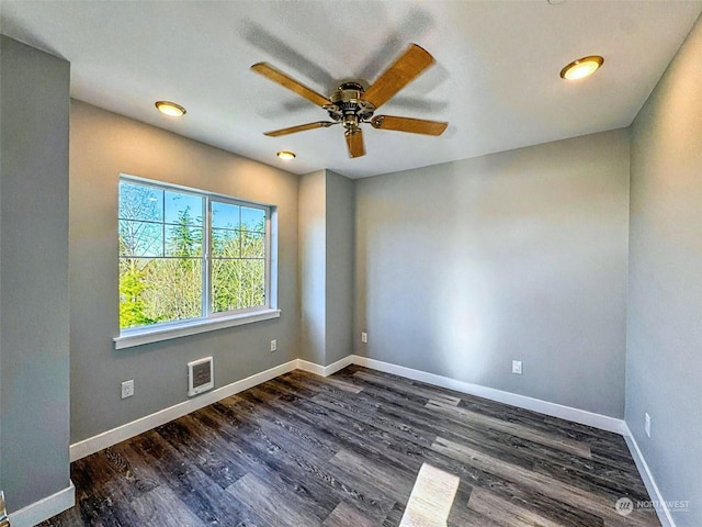 spare room with dark hardwood / wood-style floors and ceiling fan