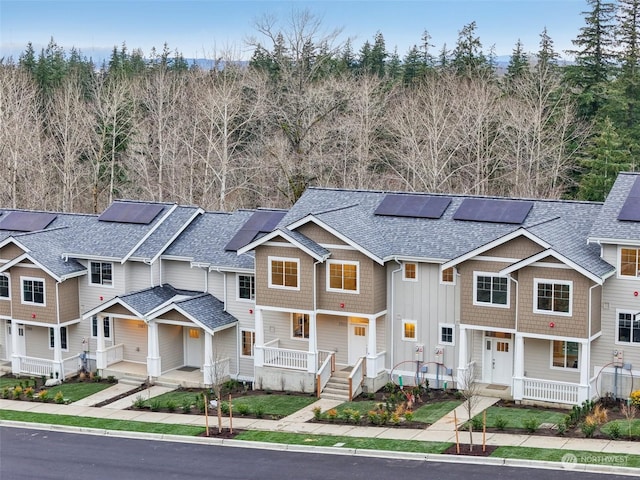 view of front facade featuring a porch and solar panels