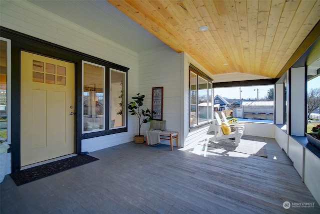 unfurnished sunroom with lofted ceiling and wooden ceiling