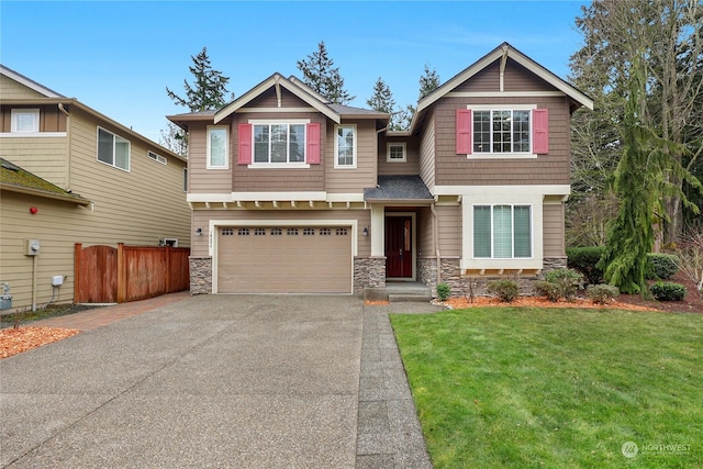 craftsman house with a garage and a front lawn