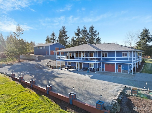 back of property featuring a garage