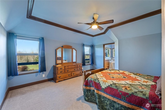 bedroom featuring multiple windows, a tray ceiling, crown molding, and carpet flooring