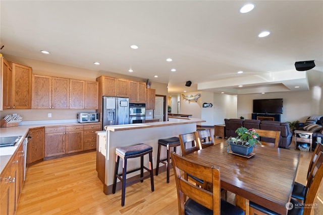 dining area featuring sink and light hardwood / wood-style floors