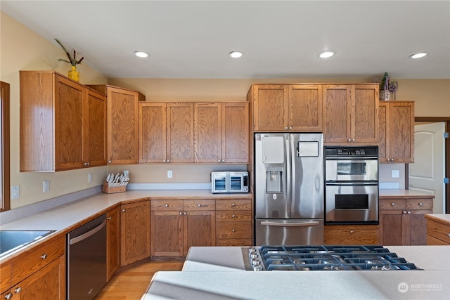 kitchen with stainless steel appliances and light wood-type flooring