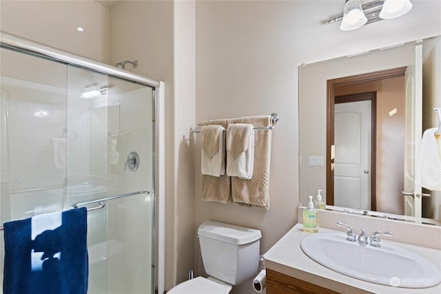 bathroom with vanity, toilet, and walk in shower