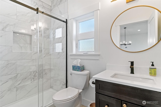 bathroom featuring an enclosed shower, vanity, a notable chandelier, and toilet