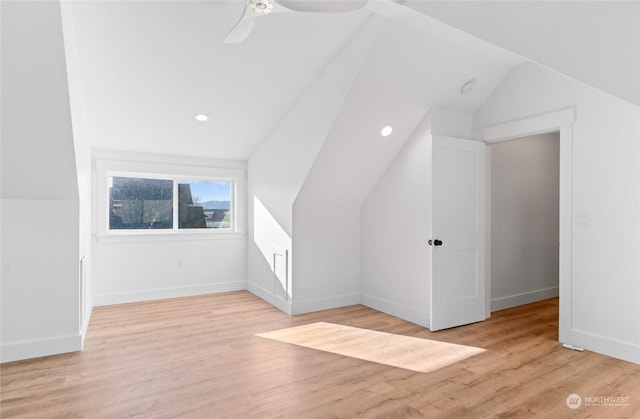 bonus room featuring ceiling fan, vaulted ceiling, and light wood-type flooring