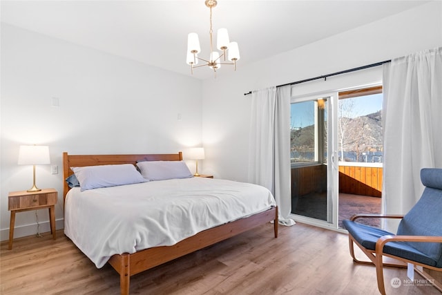 bedroom featuring an inviting chandelier and light wood-type flooring