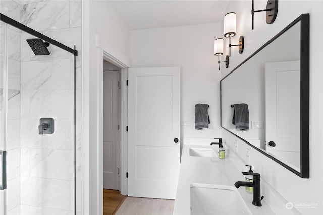 bathroom featuring vanity, hardwood / wood-style floors, and walk in shower