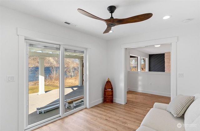 sitting room featuring light hardwood / wood-style flooring and ceiling fan