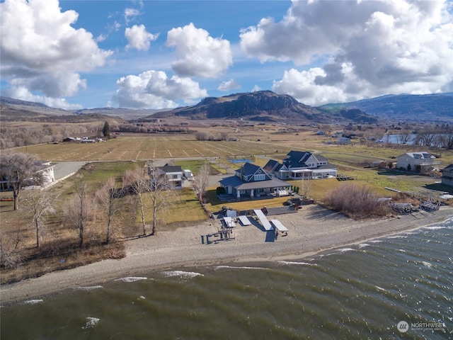 birds eye view of property featuring a rural view and a water and mountain view