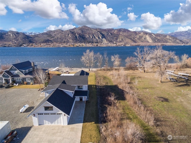 drone / aerial view featuring a water and mountain view