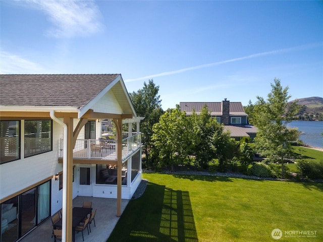 33 Hard Cider Dr, Oroville, WA 98844 - view of green lawn featuring a balcony, a patio area, and a water view