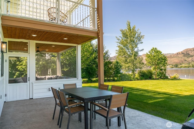 33 Hard Cider Dr, Oroville, WA 98844 - view of patio / terrace featuring a balcony, outdoor dining space, a water and mountain view, and a sunroom