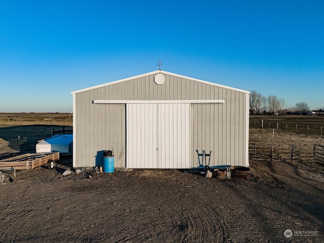 view of outdoor structure with a rural view