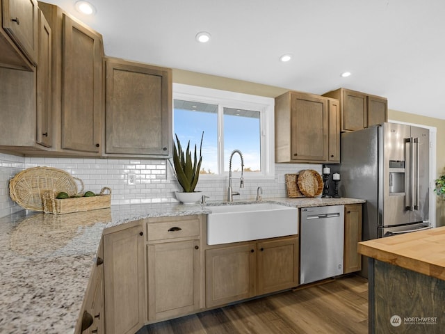 kitchen with sink, tasteful backsplash, wooden counters, dark hardwood / wood-style floors, and stainless steel appliances