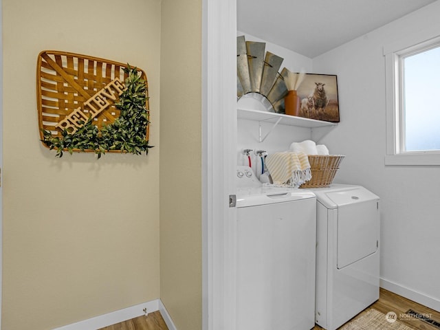 laundry area with independent washer and dryer and light wood-type flooring