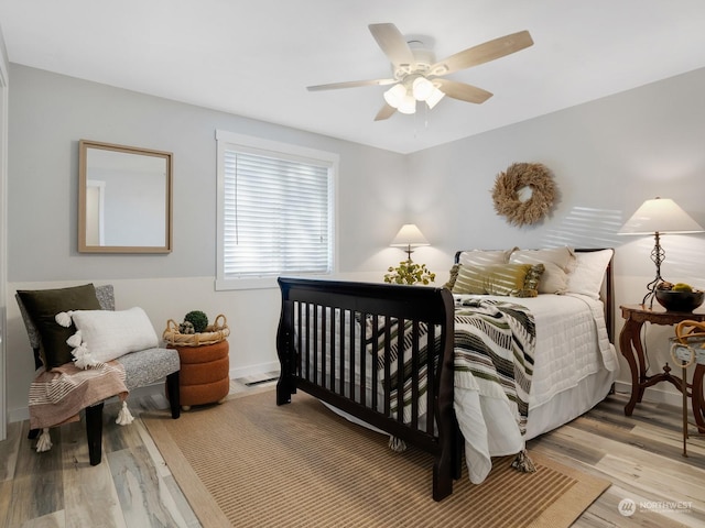 bedroom with ceiling fan and light wood-type flooring