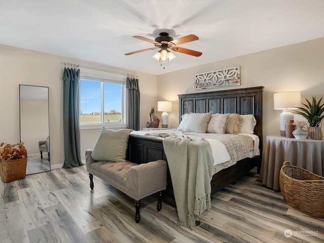 bedroom with hardwood / wood-style floors and ceiling fan