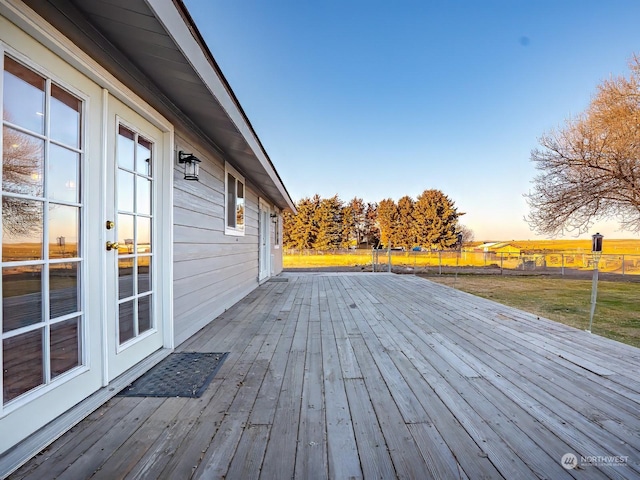 deck at dusk with a lawn