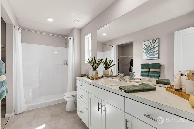 bathroom featuring vanity, toilet, and walk in shower