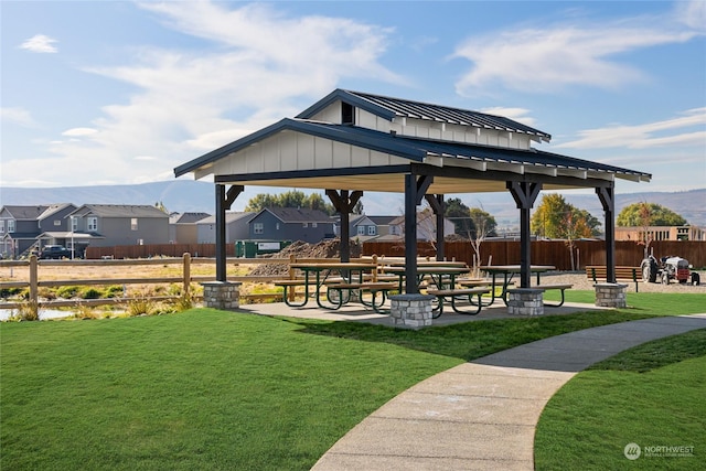 surrounding community with a gazebo and a yard