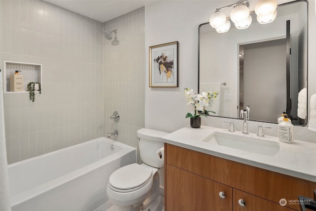 full bathroom featuring tiled shower / bath combo, vanity, and toilet