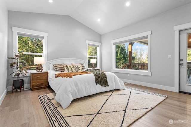 bedroom with lofted ceiling and hardwood / wood-style floors