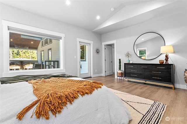 bedroom with vaulted ceiling and light hardwood / wood-style flooring