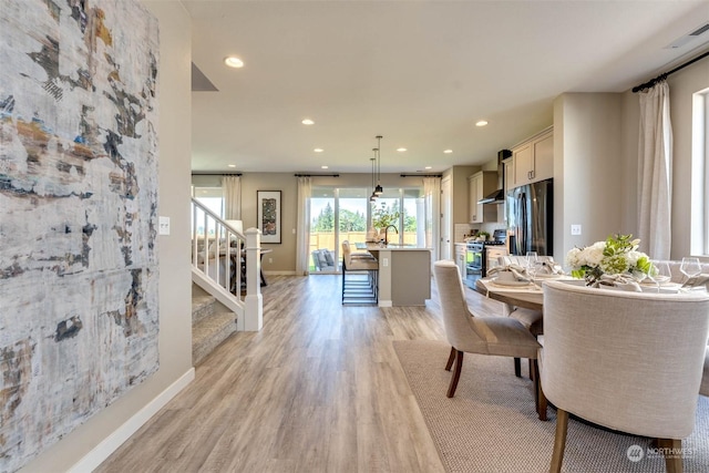 dining area with light hardwood / wood-style flooring