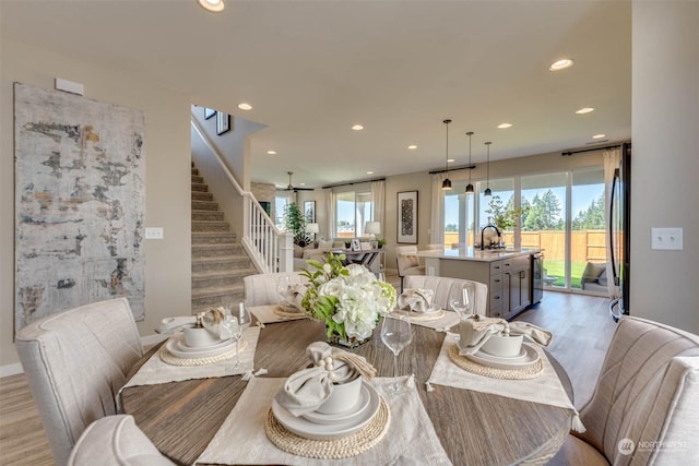 dining area featuring sink and light wood-type flooring