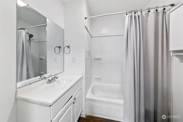 bathroom featuring vanity, shower / bathtub combination with curtain, and hardwood / wood-style floors