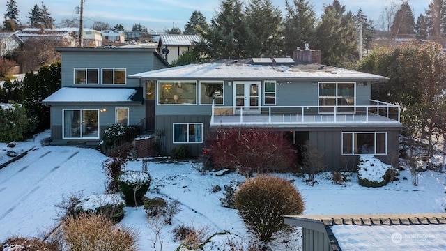 view of snow covered rear of property