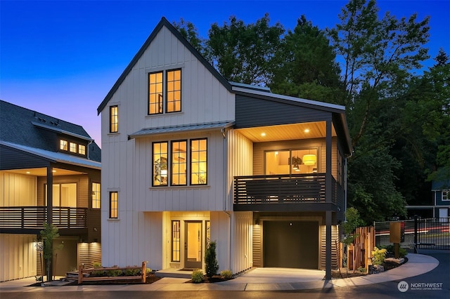 view of front of home with a garage and a balcony