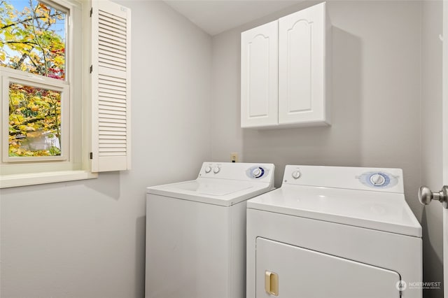 laundry area with cabinets, washing machine and dryer, and a healthy amount of sunlight