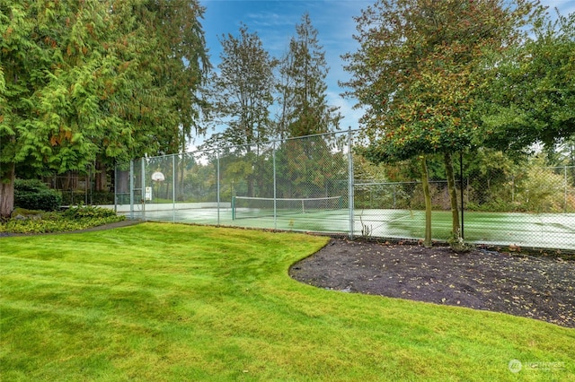 view of tennis court with a lawn