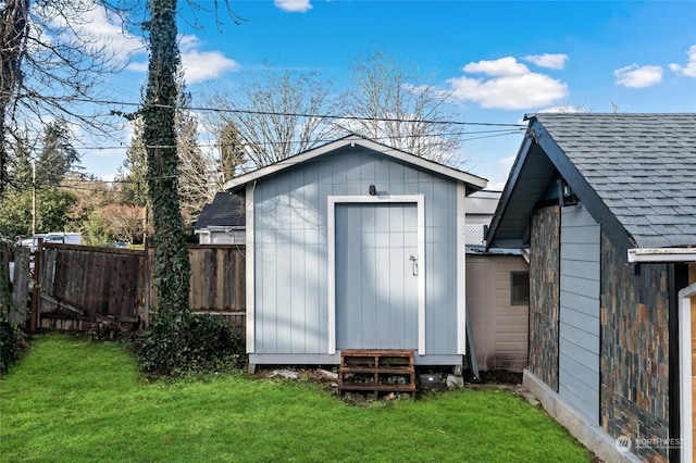 view of shed featuring fence