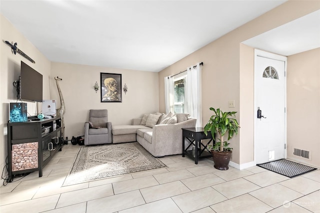 living room with light tile patterned floors and visible vents