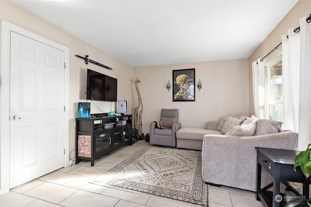 living area featuring a barn door and light tile patterned flooring