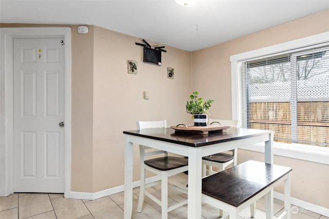 dining room featuring light tile patterned flooring and baseboards