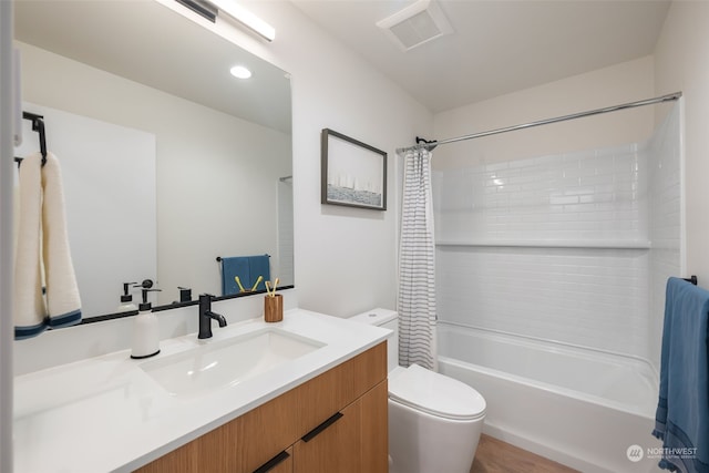 full bathroom featuring vanity, shower / bath combination with curtain, and toilet