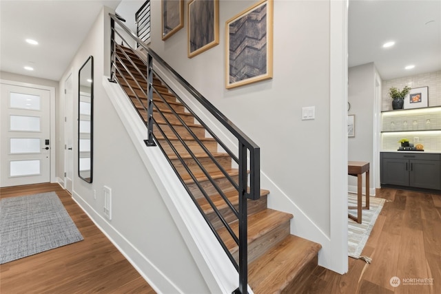 staircase with wood-type flooring