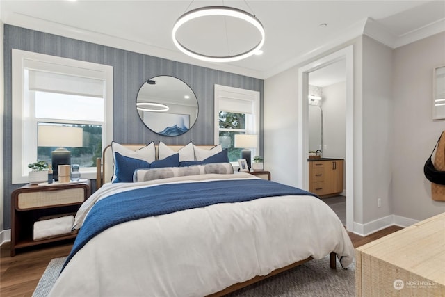 bedroom featuring dark hardwood / wood-style flooring, ornamental molding, and ensuite bath