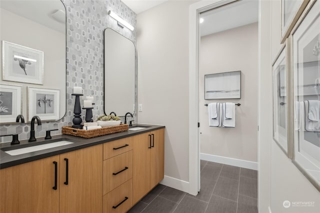 bathroom featuring tile patterned floors, vanity, and backsplash