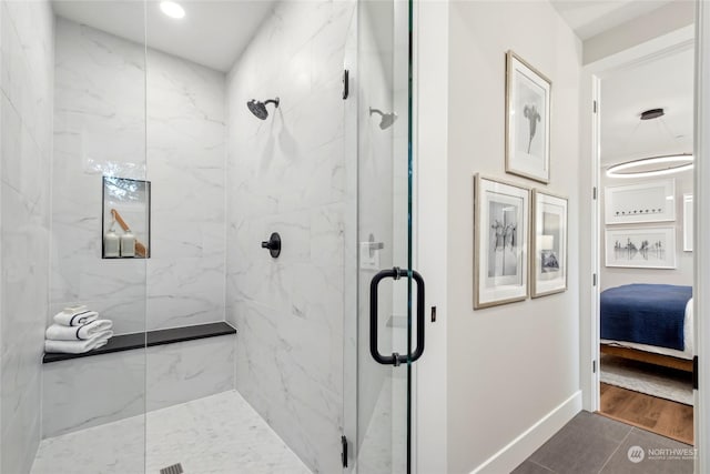 bathroom with tile patterned floors and walk in shower