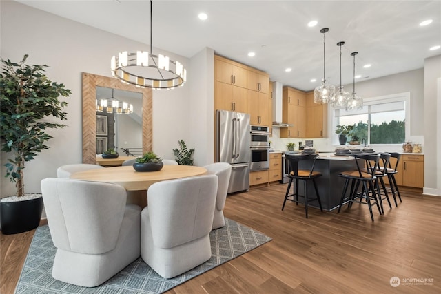 dining room featuring hardwood / wood-style flooring and a chandelier