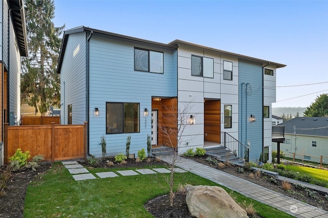 modern home featuring a front lawn